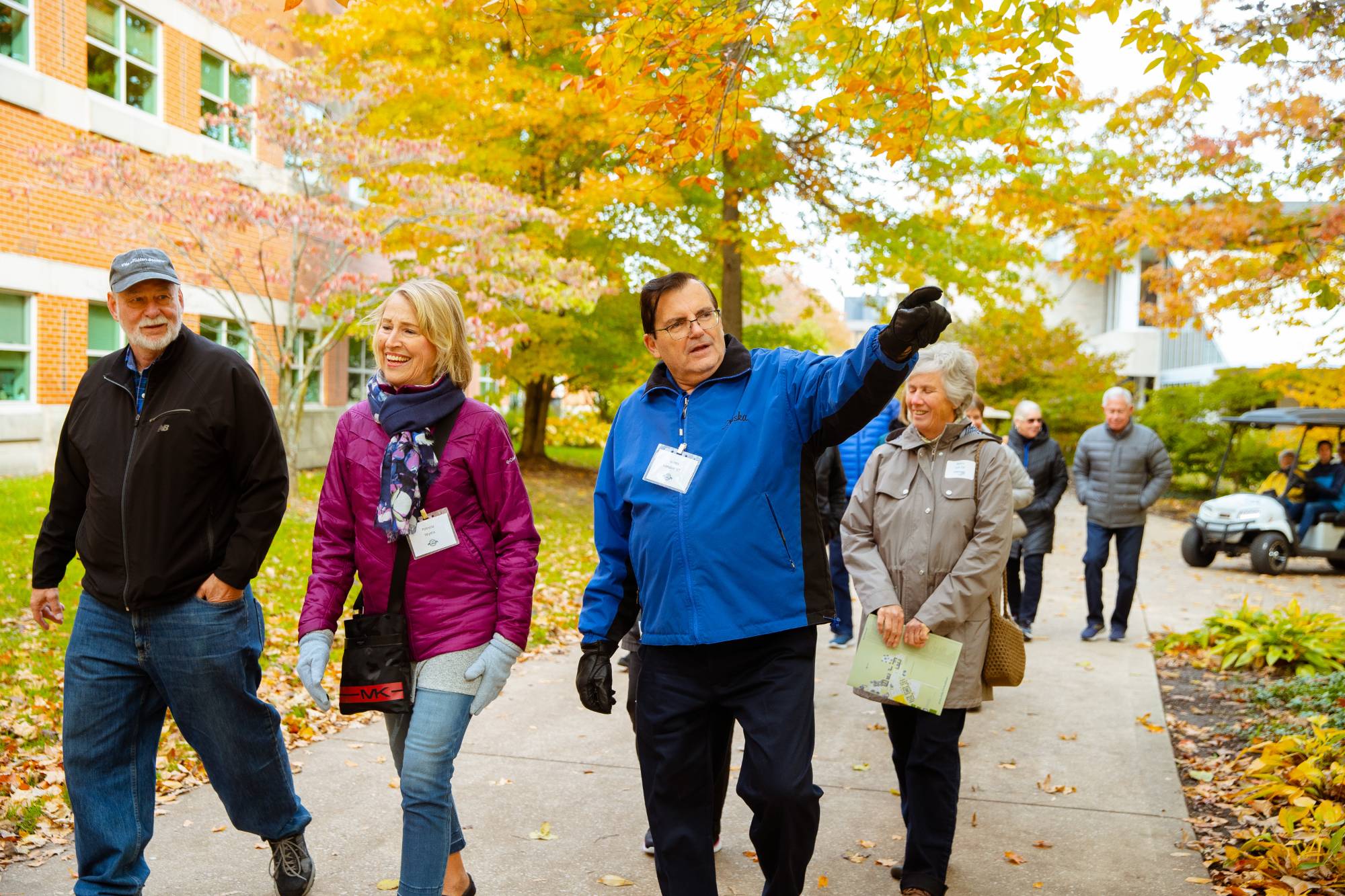 Alumni walk on campus during a guided campus tour